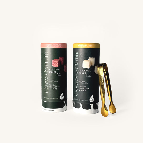 Cosmo and Lemon Drop Martini Tallboys in dark green cylindrical packaging on an off white background