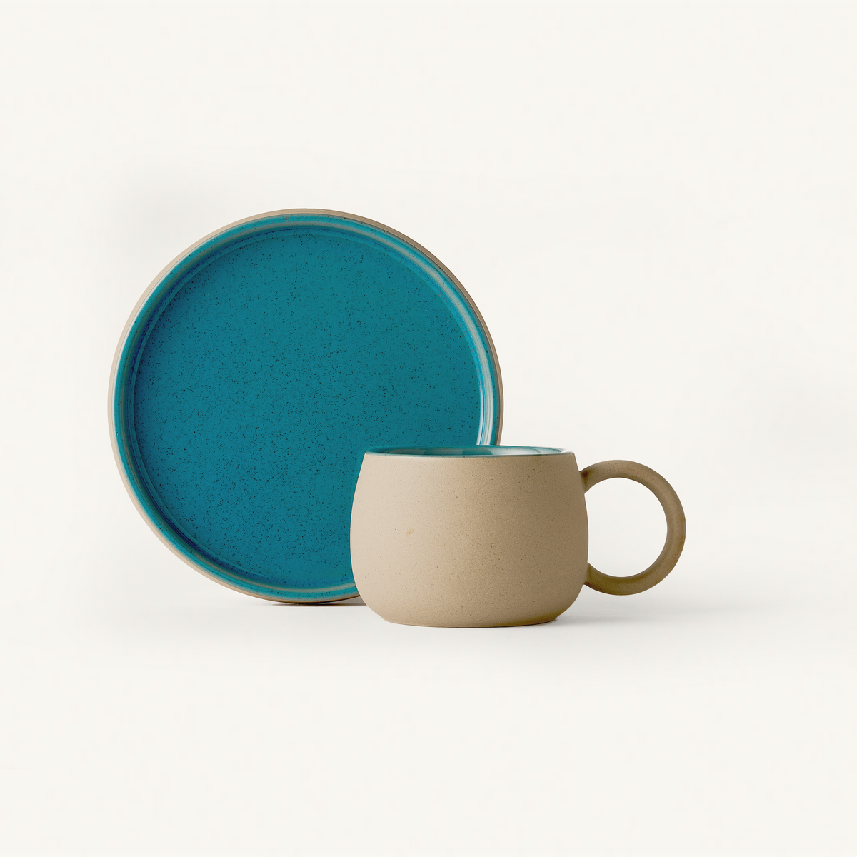 Textured Stone mug and Saucer with smooth Blue glaze on inside and top surface.