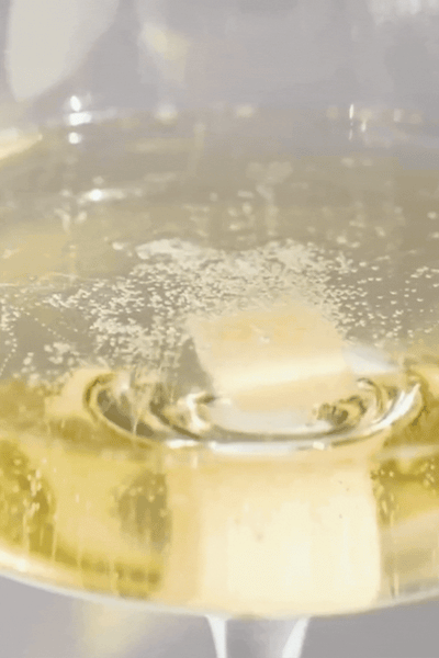 A packaged Instant Mimosa Kit by Teaspressa, containing yellow and beige sugar cubes in a white box with gold accents.