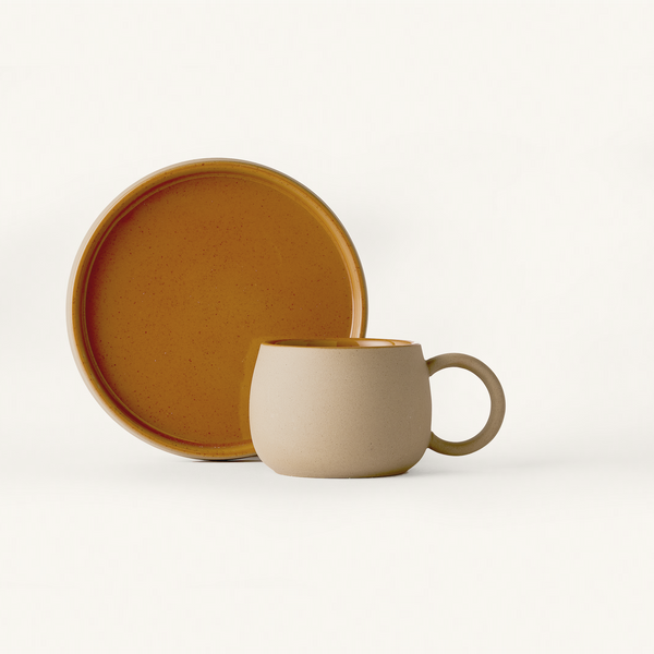 Textured Stone mug and Saucer with smooth orange glaze on inside and top surface.