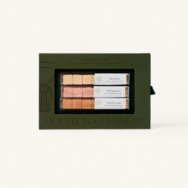 Set of bourbon cocktail mixers in a green box on a white background