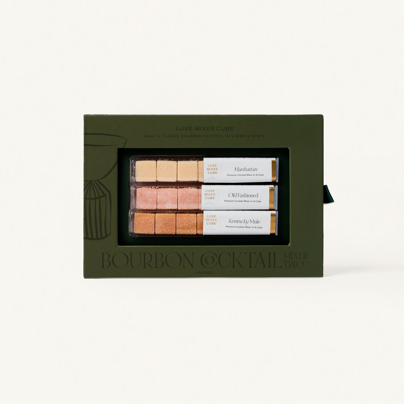 Set of bourbon cocktail mixers in a green box on a white background