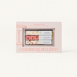 Packaged set of Champagne Bellini mixer cubes with a pink box on a white background