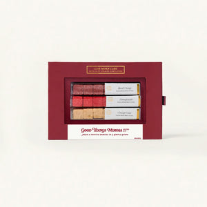 Red gift box with a window displaying three small bottles of wine on a white background