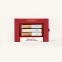 Red gift box with Christmas tea packages on a white background