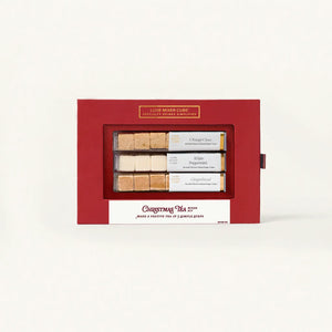 Red gift box with Christmas tea packages on a white background