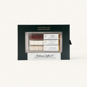 A boxed set labeled Clubhouse Coffee Café Set containing flavored drink cubes in three varieties: Cinnamon Brown Sugar, White Chocolate Mocha, and French Vanilla, displayed in a green and cream package.