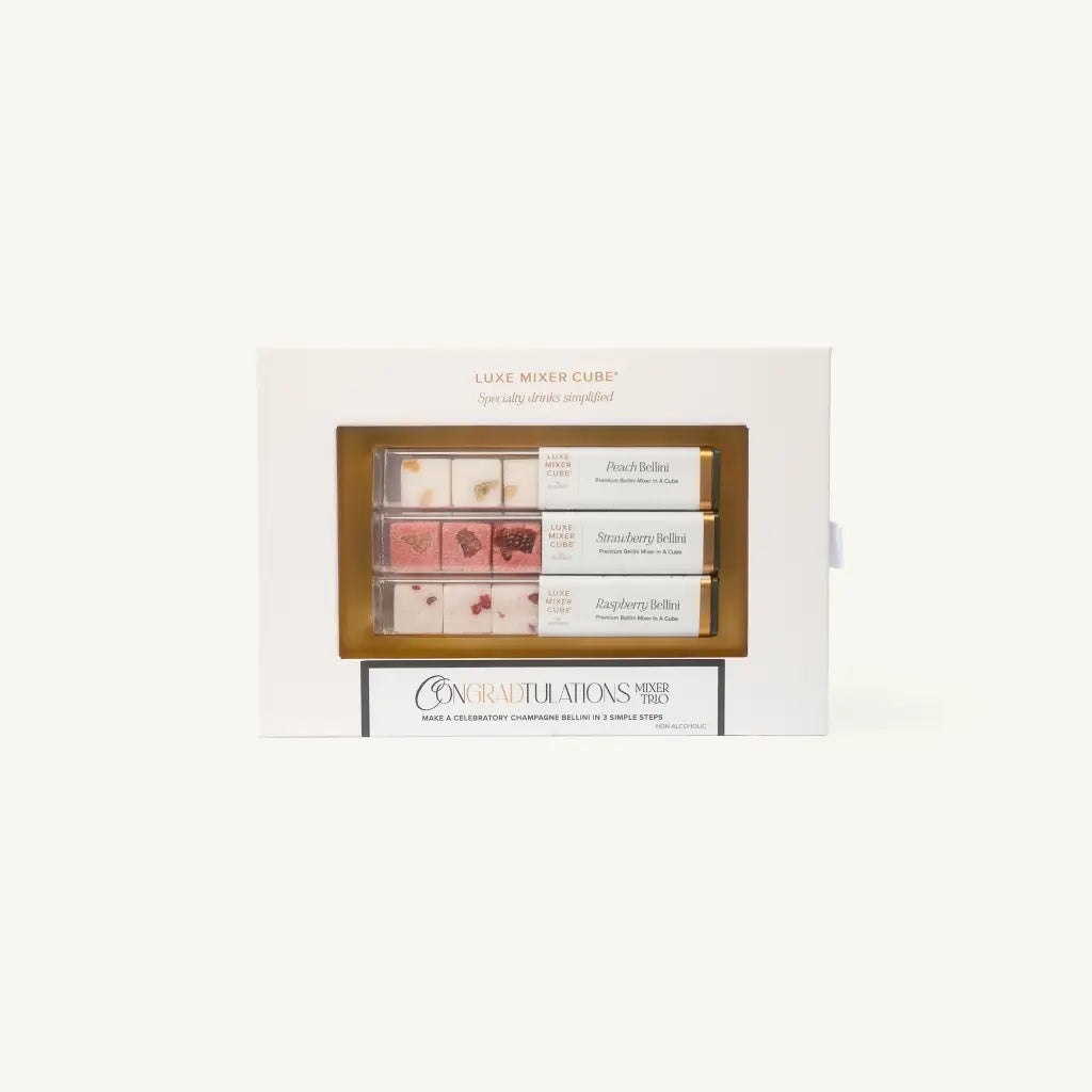 A gift box labeled Luxe Mixer Cube with three rows of cocktail mixer cubes in flavors: Peach Bellini, Strawberry Bellini, and Raspberry Bellini. The box has a Congra'd'tulations message on the front.