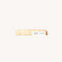 A row of small square pale beige product pieces arranged horizontally on a clean off-white background, with a small label reading 'LUXE MINI' and 'HONEY GINGER 24g'.