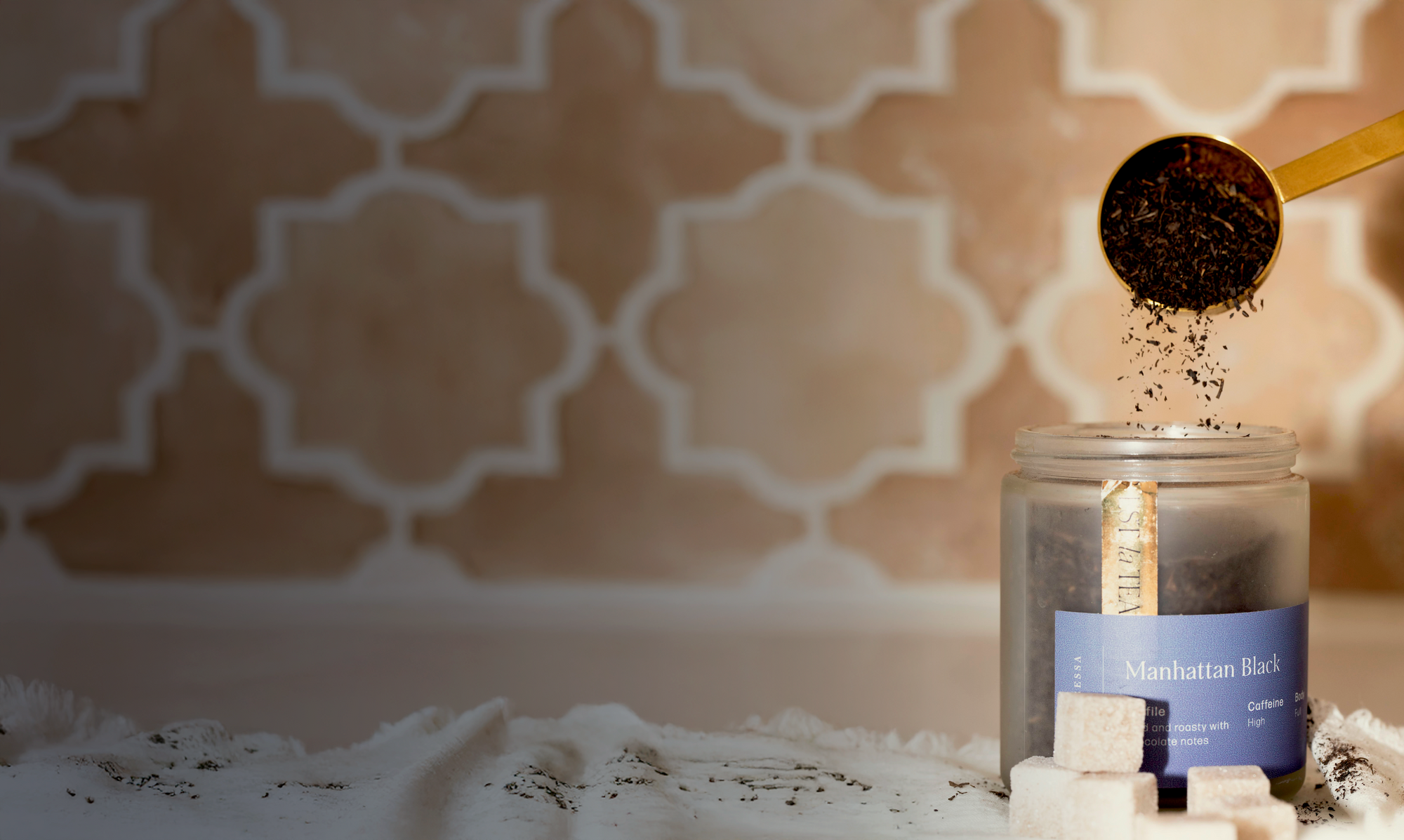 Candle being lit with a decorative patterned wall in the background