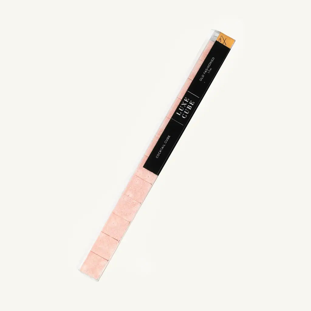 Pink makeup pencil with black label on a white background