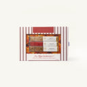 A boxed food product on a plain light background. The package is white with vertical red stripes and a clear front window showing three rectangular mimosa bars with cream-colored tops and red sides.