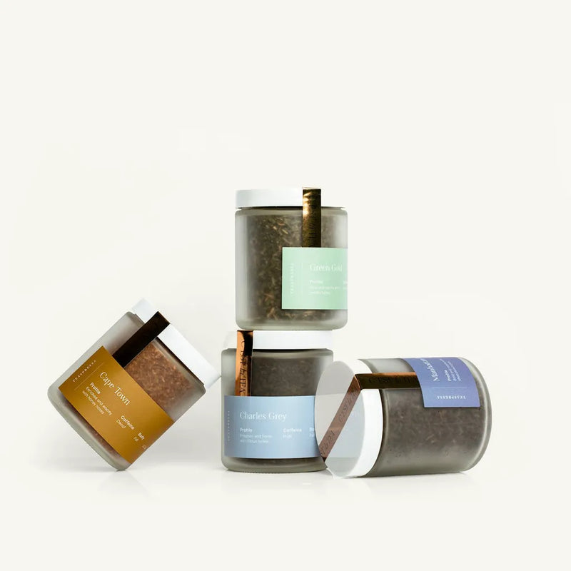 Set of cylindrical containers with labels on a white background