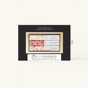 A Luxe Mixer Cube set featuring three flavors: Peach, Strawberry, and Raspberry Bellini, packaged in a black box with a gold frame and a "Congradtulations" label.