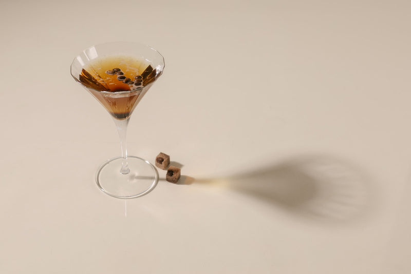 Martini glass with a cocktail on a beige background