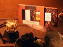 Hands holding Pecan Pie Latte Mixer Kit with Pecan, Vanilla Brown Sugar, Salted Honey sugar cubes. Dessert scene with pecan pie and more sugar.